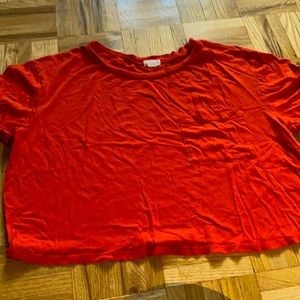 Plain orange crop-top with pocket.